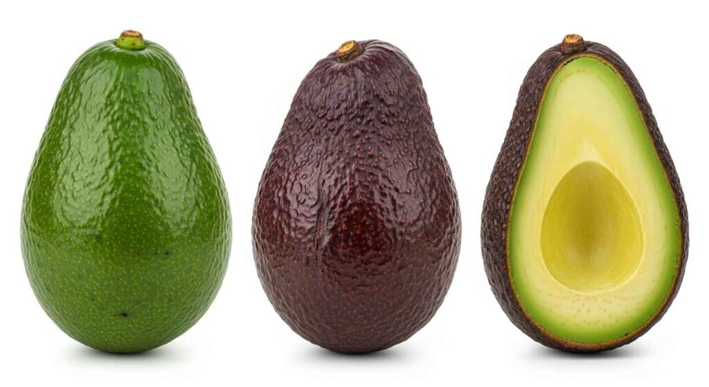 Three avocados showing green hard, dark firm, and soft ripe stages.