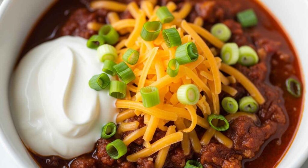 Served chili in a bowl with toppings.